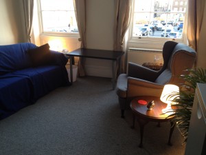 The therapy room is on the first floor, tucked away. There is a small waiting area on the landing.
